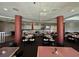 A spacious dining room features tables with a mix of dark and light chairs, plus gray walls with red pillar accents for a modern feel at 4800 S Ocean Blvd. # 706, North Myrtle Beach, SC 29582