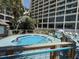 View of a round hot tub with a person in it and the resort building in the background at 4800 S Ocean Blvd. # 706, North Myrtle Beach, SC 29582