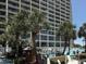 Beautiful outdoor pool area with palm trees and views of the condo building at 4800 S Ocean Blvd. # 706, North Myrtle Beach, SC 29582