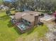 Aerial view of a brick home with a patio, mature landscaping, and a well-manicured lawn at 52 Trimmings Ct., Pawleys Island, SC 29585