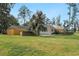 Expansive backyard featuring a well-maintained lawn, brick patio, and privacy fence at 52 Trimmings Ct., Pawleys Island, SC 29585