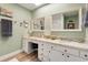 Bright bathroom featuring dual sinks, a vanity area, and a neutral palette at 52 Trimmings Ct., Pawleys Island, SC 29585