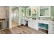 Spacious bathroom with double vanity, decorative mirrors, and modern wood-look floors at 52 Trimmings Ct., Pawleys Island, SC 29585