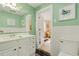 Bathroom featuring green walls, white cabinets, tile, and an adjacent room beyond the doorway at 52 Trimmings Ct., Pawleys Island, SC 29585
