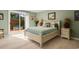 Cozy bedroom with sliding glass door to private patio, complemented by coastal decor and natural light at 52 Trimmings Ct., Pawleys Island, SC 29585