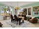 Elegant dining room with chandelier and scenic views from multiple windows at 52 Trimmings Ct., Pawleys Island, SC 29585