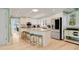Open concept kitchen with island seating and stainless steel refrigerator at 52 Trimmings Ct., Pawleys Island, SC 29585