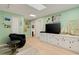 Bright living room with skylight, green walls, white shelving, and light hardwood flooring at 52 Trimmings Ct., Pawleys Island, SC 29585