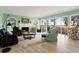 Bright living room boasts stylish furniture, fireplace, and scenic views through large windows at 52 Trimmings Ct., Pawleys Island, SC 29585