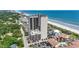 An aerial view shows a high-rise building with ocean views and a beautiful beach at 5523 N Ocean Blvd. # 1412, Myrtle Beach, SC 29577