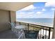 Enjoy ocean views from this well-appointed balcony with table and chairs at 5523 N Ocean Blvd. # 1412, Myrtle Beach, SC 29577