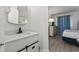 Bright bathroom features a modern vanity with black fixtures, and a glimpse of the bedroom at 5523 N Ocean Blvd. # 1412, Myrtle Beach, SC 29577