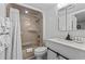 Clean bathroom with shower and tub combination featuring white tiling, white toilet, and a stylish vanity at 5523 N Ocean Blvd. # 1412, Myrtle Beach, SC 29577