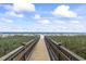 Picturesque boardwalk leading to a beautiful beach with white sand and blue ocean views at 5523 N Ocean Blvd. # 1412, Myrtle Beach, SC 29577