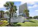 Exterior view of Ocean Forest Plaza with palm trees, and lush landscaping at 5523 N Ocean Blvd. # 1412, Myrtle Beach, SC 29577
