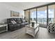 A cozy living room boasts balcony access and ocean views at 5523 N Ocean Blvd. # 1412, Myrtle Beach, SC 29577