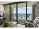 Bright living area with sliding glass door to balcony with table and chairs overlooking the ocean at 5523 N Ocean Blvd. # 1412, Myrtle Beach, SC 29577