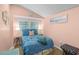 Serene bedroom with a plush blue comforter, soft lighting, and a relaxing ambiance at 6001 - 1040 S Kings Hwy., Myrtle Beach, SC 29575