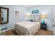 Comfortable bedroom with a queen-sized bed, driftwood mirror, and ocean decor at 6001 - 1040 S Kings Hwy., Myrtle Beach, SC 29575
