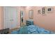 Light-filled bedroom features coastal decor, pink walls, and quaint furnishings for a beachy feel at 6001 - 1040 S Kings Hwy., Myrtle Beach, SC 29575