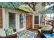 Cozy outdoor seating area on wooden deck with comfortable wicker chairs and a floral rug at 6001 - 1040 S Kings Hwy., Myrtle Beach, SC 29575