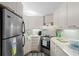 Compact kitchen featuring modern appliances, light wood cabinets, and sleek countertops at 6001 - 1040 S Kings Hwy., Myrtle Beach, SC 29575