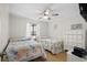 Bright bedroom with two twin beds, ceiling fan, and charming beach-themed decor at 6001 N Ocean Blvd. # 137, North Myrtle Beach, SC 29582