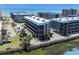A close aerial view of a multi-story condo complex highlighting the parking, balconies, and surrounding landscape at 6001 N Ocean Blvd. # 137, North Myrtle Beach, SC 29582