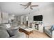 Inviting living room with light wood floors, gray sofa, TV, and partial view of a kitchen at 6001 N Ocean Blvd. # 137, North Myrtle Beach, SC 29582