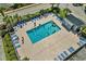 Aerial view of a sparkling community swimming pool surrounded by lounge chairs and lush landscaping on a sunny day at 6001 N Ocean Blvd. # 137, North Myrtle Beach, SC 29582