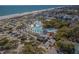 An aerial view shows a resort with an expansive pool area, waterslides, and nearby beach at 6001-1010 S Kings Highway, Myrtle Beach, SC 29575
