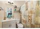 Functional bathroom with a single sink vanity, toilet, and shower with nautical themed shower curtain at 6001-1010 S Kings Highway, Myrtle Beach, SC 29575