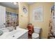 Well-lit bathroom with light colored walls, patterned shower curtain, and a white sink at 6001-1010 S Kings Highway, Myrtle Beach, SC 29575
