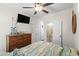 Relaxing bedroom with wooden furniture, ceiling fan, and access to an ensuite bathroom at 6001-1010 S Kings Highway, Myrtle Beach, SC 29575