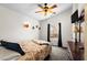 A well-lit bedroom with a charming beach-themed quilt, window, and a dresser under a TV at 6001-1010 S Kings Highway, Myrtle Beach, SC 29575