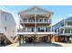 Two-story coastal home featuring dual balconies and covered parking at 6001-1010 S Kings Highway, Myrtle Beach, SC 29575