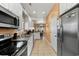 Bright kitchen with stainless steel appliances, white cabinetry, and easy access to the dining area at 6001-1010 S Kings Highway, Myrtle Beach, SC 29575