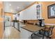 Functional kitchen with white cabinetry, modern appliances, and a convenient breakfast bar at 6001-1010 S Kings Highway, Myrtle Beach, SC 29575