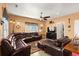 Inviting living room with a wrap around leather sofa, ceiling fan, and tv at 6001-1010 S Kings Highway, Myrtle Beach, SC 29575