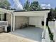 The covered carport is perfect for storage, with brick and siding and mature greenery around at 616 Mckinley Way, Conway, SC 29526
