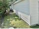 A garage exterior shows the siding of the building with grass and trees around it at 616 Mckinley Way, Conway, SC 29526