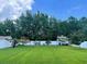 Beautiful backyard with lush green lawn, a pristine white fence, and mature trees at 620 Bathurst Dr., Myrtle Beach, SC 29579