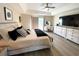 This bedroom features hardwood floors, a ceiling fan, a television, and access to a balcony at 620 Bathurst Dr., Myrtle Beach, SC 29579