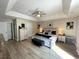 This bedroom features a tray ceiling, ceiling fan, hardwood floors, and neutral-colored walls at 620 Bathurst Dr., Myrtle Beach, SC 29579