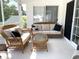 Inviting sunroom with wicker furniture, perfect for relaxing or entertaining guests at 620 Bathurst Dr., Myrtle Beach, SC 29579