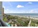 Stunning beach view with clear skies, ocean, and palm trees surrounding the pool at 6804 North Ocean Blvd. # 515, Myrtle Beach, SC 29572