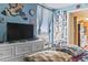 Comfortable bedroom showcasing a TV on a dresser and wall decor. Natural light filters in creating a relaxing ambiance at 6804 North Ocean Blvd. # 515, Myrtle Beach, SC 29572