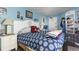 Inviting bedroom with seashell headboard, bedside lamps, a patterned comforter and beach-themed décor at 6804 North Ocean Blvd. # 515, Myrtle Beach, SC 29572