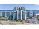 Stunning exterior shot of an ocean-front resort with blue facade, balconies, and immaculate landscaping at 6804 North Ocean Blvd. # 515, Myrtle Beach, SC 29572
