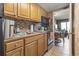 Functional kitchen equipped with wood cabinets and essential appliances, offering a glimpse of the living area at 6804 North Ocean Blvd. # 515, Myrtle Beach, SC 29572